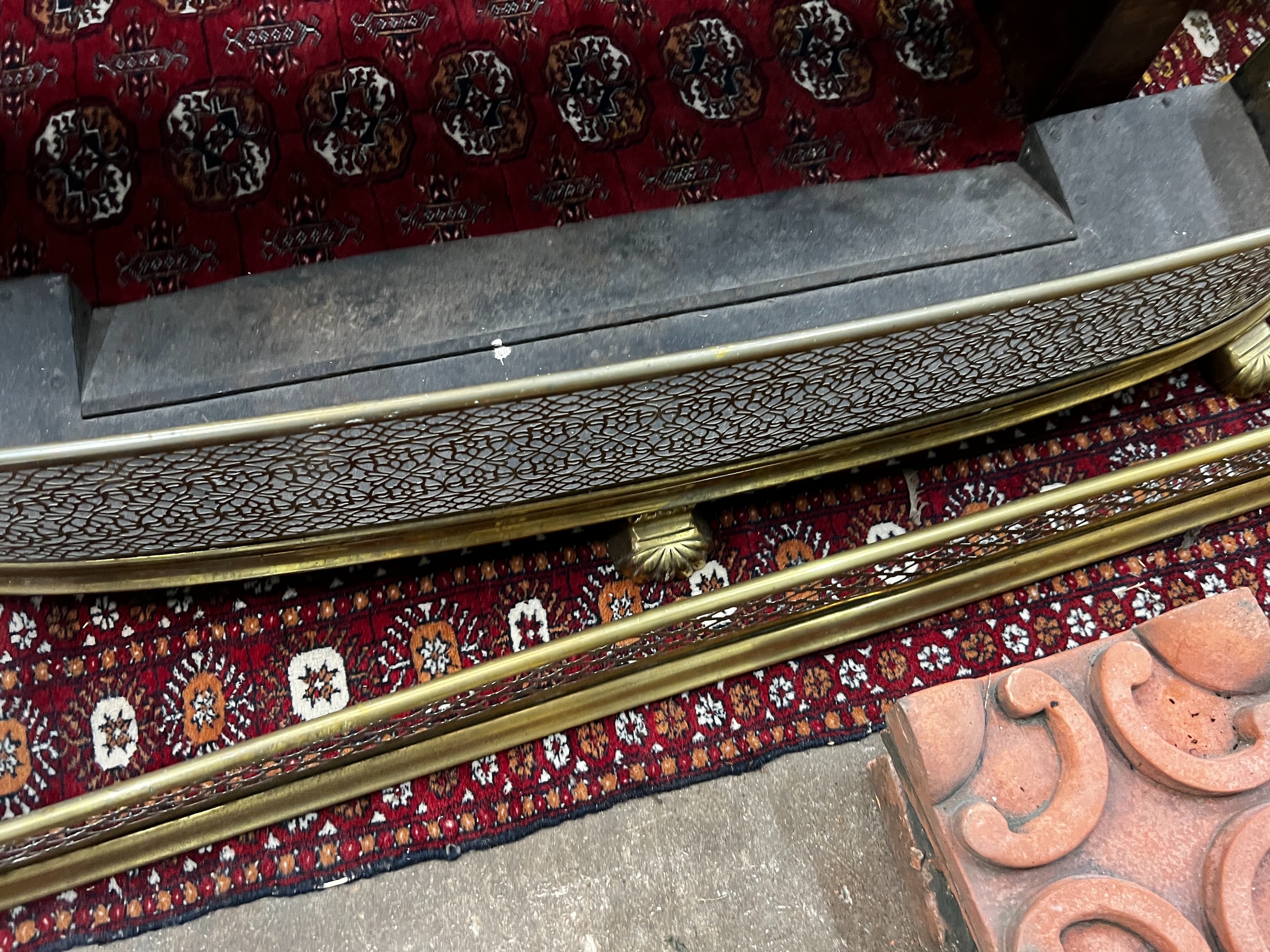 Two Victorian pierced brass fenders, larger width 123cm